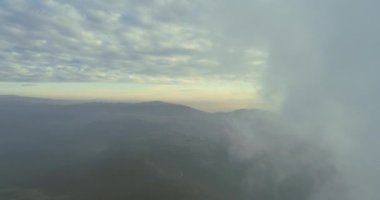Abstract aerial view of coal power plant high pipes with black smoke moving up polluting atmosphere at sunny day. High quality 4k footage