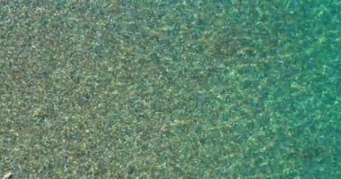 Aerial drone view of overcrowded urban lake during peak of tourist season. Crowd of people swimming in the sea at summer. Large group of people in swimsuit bathing in ocean during vacation. High