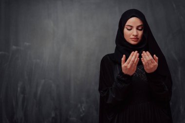 Portrait of young Muslim woman making dua. High quality photo