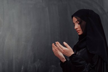 Portrait of young Muslim woman making dua. High quality photo