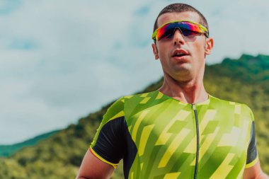 An athlete running a marathon and preparing for his competition. Photo of a marathon runner running in an urban environment. 