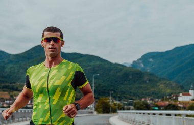 An athlete running a marathon and preparing for his competition. Photo of a marathon runner running in an urban environment. 