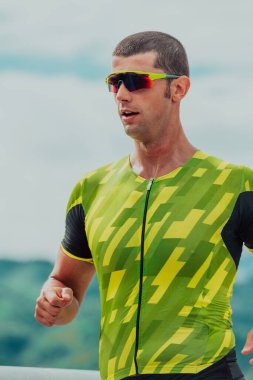 An athlete running a marathon and preparing for his competition. Photo of a marathon runner running in an urban environment. 