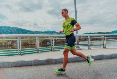 An athlete running a marathon and preparing for his competition. Photo of a marathon runner running in an urban environment. 