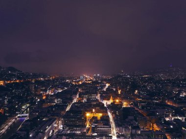 Sarajevo city hall or national library in town center aerialhyper lapse or time lapse. Landmark in capital of Bosnia and Herzegovina covered with fresh snow in the winter season at night. Hi quality