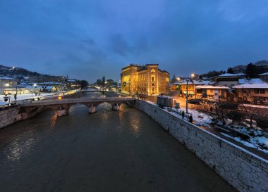 Sarajevo city hall or national library in town center aerialhyper lapse or time lapse. Landmark in capital of Bosnia and Herzegovina covered with fresh snow in the winter season at night. Hi quality