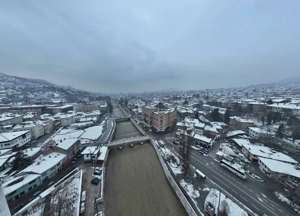 Sarajevo city hall or national library in town center aerialhyper lapse or time lapse. Landmark in capital of Bosnia and Herzegovina covered with fresh snow in the winter season at night. Hi quality