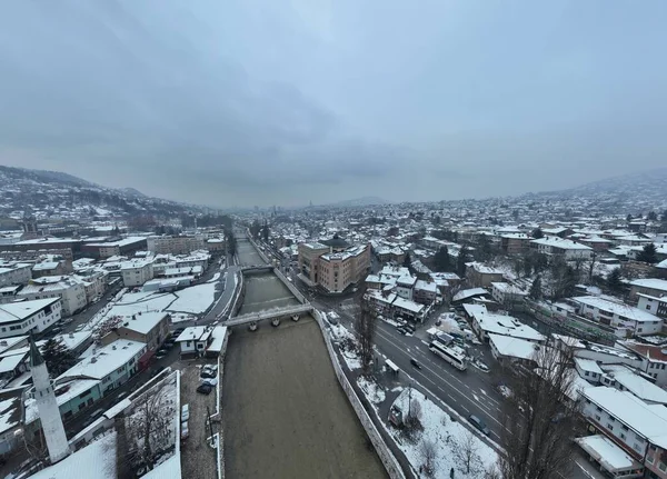 Sarajevo city hall or national library in town center aerialhyper lapse or time lapse. Landmark in capital of Bosnia and Herzegovina covered with fresh snow in the winter season at night. Hi quality