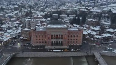 Sarajevo city hall or national library in town center aerialhyper lapse or time lapse. Landmark in capital of Bosnia and Herzegovina covered with fresh snow in the winter season at night. Hi quality