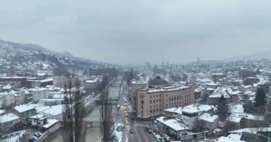 Sarajevo city hall or national library in town center aerialhyper lapse or time lapse. Landmark in capital of Bosnia and Herzegovina covered with fresh snow in the winter season at night. Hi quality