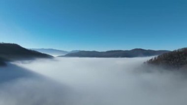 Aerial View. Flying over the high mountains in beautiful clouds. Aerial Drone camera shot. Air pollution clouds over Sarajevo in Bosnia and Herzegovina. Hi quality 4K footage. 