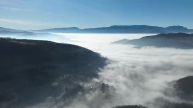 Aerial View. Flying over the high mountains in beautiful clouds. Aerial Drone camera shot. Air pollution clouds over Sarajevo in Bosnia and Herzegovina. Hi quality 4K footage. 