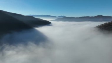 Aerial View. Flying over the high mountains in beautiful clouds. Aerial Drone camera shot. Air pollution clouds over Sarajevo in Bosnia and Herzegovina. Hi quality 4K footage. 
