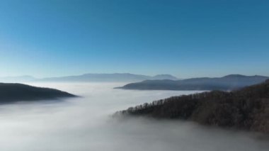 Aerial View. Flying over the high mountains in beautiful clouds. Aerial Drone camera shot. Air pollution clouds over Sarajevo in Bosnia and Herzegovina. Hi quality 4K footage. 