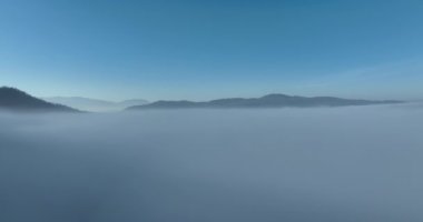 Aerial View. Flying over the high mountains in beautiful clouds. Aerial Drone camera shot. Air pollution clouds over Sarajevo in Bosnia and Herzegovina. Hi quality 4K footage. 