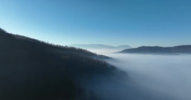 Aerial View. Flying over the high mountains in beautiful clouds. Aerial Drone camera shot. Air pollution clouds over Sarajevo in Bosnia and Herzegovina. Hi quality 4K footage. 