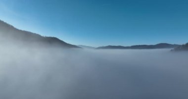 Aerial View. Flying over the high mountains in beautiful clouds. Aerial Drone camera shot. Air pollution clouds over Sarajevo in Bosnia and Herzegovina. Hi quality 4K footage. 