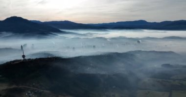 Aerial View. Flying over the high mountains in beautiful clouds. Aerial Drone camera shot. Air pollution clouds over Sarajevo in Bosnia and Herzegovina. Hi quality 4K footage. 