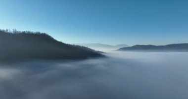 Aerial View. Flying over the high mountains in beautiful clouds. Aerial Drone camera shot. Air pollution clouds over Sarajevo in Bosnia and Herzegovina. Hi quality 4K footage. 