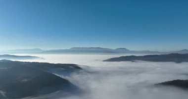 Aerial View. Flying over the high mountains in beautiful clouds. Aerial Drone camera shot. Air pollution clouds over Sarajevo in Bosnia and Herzegovina. Hi quality 4K footage. 