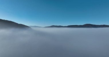 Aerial View. Flying over the high mountains in beautiful clouds. Aerial Drone camera shot. Air pollution clouds over Sarajevo in Bosnia and Herzegovina. Hi quality 4K footage. 