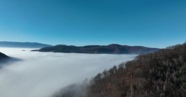 Aerial View. Flying over the high mountains in beautiful clouds. Aerial Drone camera shot. Air pollution clouds over Sarajevo in Bosnia and Herzegovina. Hi quality 4K footage. 