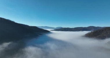 Aerial View. Flying over the high mountains in beautiful clouds. Aerial Drone camera shot. Air pollution clouds over Sarajevo in Bosnia and Herzegovina. Hi quality 4K footage. 