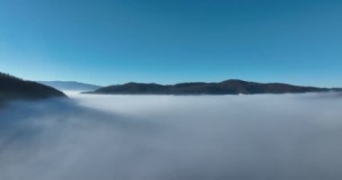 Aerial View. Flying over the high mountains in beautiful clouds. Aerial Drone camera shot. Air pollution clouds over Sarajevo in Bosnia and Herzegovina. Hi quality 4K footage. 