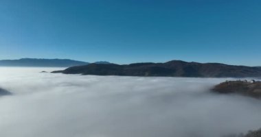 Aerial View. Flying over the high mountains in beautiful clouds. Aerial Drone camera shot. Air pollution clouds over Sarajevo in Bosnia and Herzegovina. Hi quality 4K footage. 