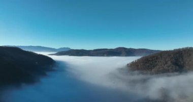 Aerial View. Flying over the high mountains in beautiful clouds. Aerial Drone camera shot. Air pollution clouds over Sarajevo in Bosnia and Herzegovina. Hi quality 4K footage. 