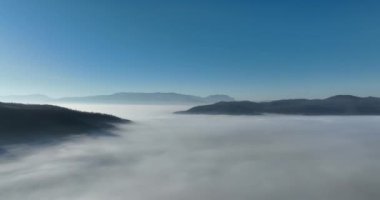 Aerial View. Flying over the high mountains in beautiful clouds. Aerial Drone camera shot. Air pollution clouds over Sarajevo in Bosnia and Herzegovina. Hi quality 4K footage. 