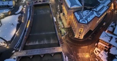 Sarajevo city hall or national library in town center aerialhyper lapse or time lapse. Landmark in capital of Bosnia and Herzegovina covered with fresh snow in the winter season at night. Hi quality