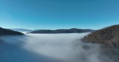 Aerial View. Flying over the high mountains in beautiful clouds. Aerial Drone camera shot. Air pollution clouds over Sarajevo in Bosnia and Herzegovina. Hi quality 4K footage. 