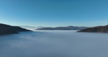 Aerial View. Flying over the high mountains in beautiful clouds. Aerial Drone camera shot. Air pollution clouds over Sarajevo in Bosnia and Herzegovina. Hi quality 4K footage. 