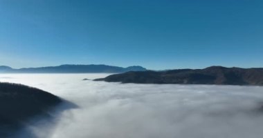 Aerial View. Flying over the high mountains in beautiful clouds. Aerial Drone camera shot. Air pollution clouds over Sarajevo in Bosnia and Herzegovina. Hi quality 4K footage. 