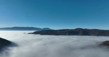 Aerial View. Flying over the high mountains in beautiful clouds. Aerial Drone camera shot. Air pollution clouds over Sarajevo in Bosnia and Herzegovina. Hi quality 4K footage. 
