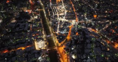 Sarajevo city hall or national library in town center aerialhyper lapse or time lapse. Landmark in capital of Bosnia and Herzegovina covered with fresh snow in the winter season at night. Hi quality