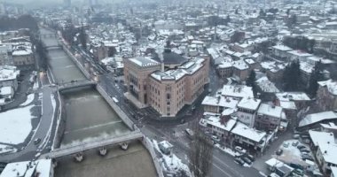Sarajevo city hall or national library in town center aerialhyper lapse or time lapse. Landmark in capital of Bosnia and Herzegovina covered with fresh snow in the winter season at night. Hi quality