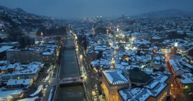 Sarajevo city hall or national library in town center aerialhyper lapse or time lapse. Landmark in capital of Bosnia and Herzegovina covered with fresh snow in the winter season at night. Hi quality