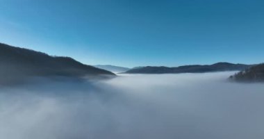 Aerial View. Flying over the high mountains in beautiful clouds. Aerial Drone camera shot. Air pollution clouds over Sarajevo in Bosnia and Herzegovina. Hi quality 4K footage. 