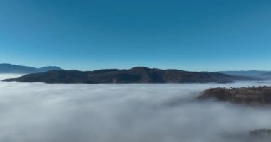 Aerial View. Flying over the high mountains in beautiful clouds. Aerial Drone camera shot. Air pollution clouds over Sarajevo in Bosnia and Herzegovina. Hi quality 4K footage. 