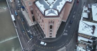 Sarajevo city hall or national library in town center aerialhyper lapse or time lapse. Landmark in capital of Bosnia and Herzegovina covered with fresh snow in the winter season at night. Hi quality