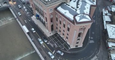 Sarajevo city hall or national library in town center aerialhyper lapse or time lapse. Landmark in capital of Bosnia and Herzegovina covered with fresh snow in the winter season at night. Hi quality