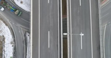 Aerial view of mountain twisted road in the winter. Epic, snowy white winter in the mountains. High rocky mountains and clean road through frozen forest. High quality 4k footage