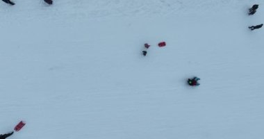 Many skiers and snowboarders skiing down on snowy mountainsides slopes in mountains at ski resort in winter. Family and friends have fun on fresh snow sliding. Bjelasnica mountain. Quality 4k video