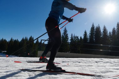 Nordic skiing or Cross-country skiing classic technique practiced by man in a beautiful panoramic trail at morning. Selective focus 