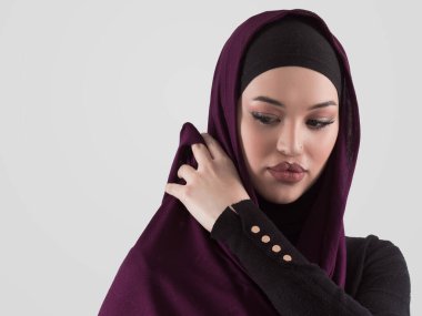 Muslim woman wearing modern stylish wear and hijab isolated on grey background. Diverse people model hijab fashion concept. High quality photo