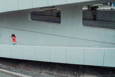 Women in sports clothes running in a modern urban environment. The concept of a sporty and healthy lifestyle. 