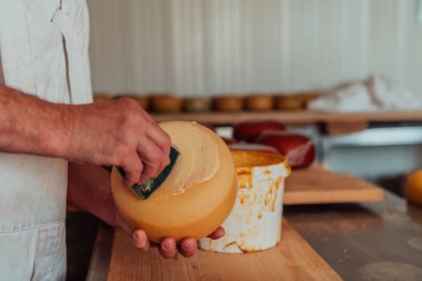 Cheese maker working in the industry for manual production of homemade cheese.