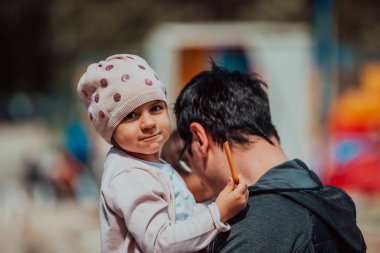 Family time in the park. Father have fun with his daughter in the park, playing fun games and spending time together. 